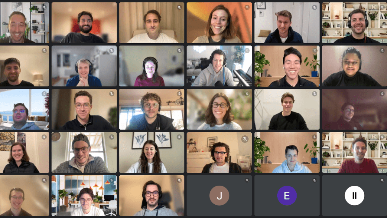 A group of 25 people participating in a virtual meeting, each in their own home or office setting.